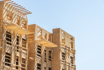 Modern apartment building under construction. The site with wooden frame in Vancouver, Canada,...