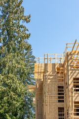 Modern apartment building under construction. The site with wooden frame in Vancouver, Canada,...