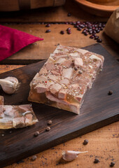 Jellied meat on a dark wooden board in the kitchen