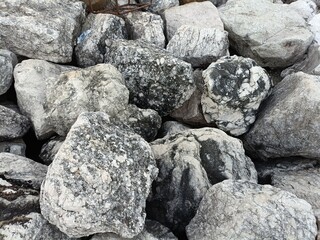 A close-up view showcasing a pile of various textured, grey rocks.