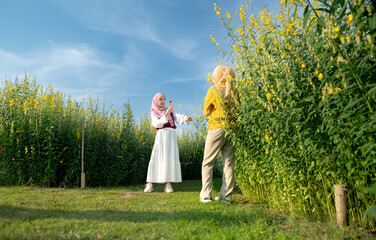 Fototapeta premium Two young Muslim women enjoying a vacation in a local park