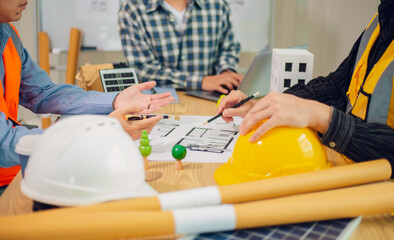 Engineers and architects discuss and consider construction plans for new renewable energy project...