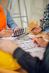 Engineers and architects discuss and consider construction plans for new renewable energy project...