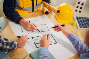 Engineers and architects discuss and consider construction plans for new renewable energy project...