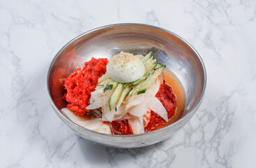 Cold Buckwheat Noodles (Korean cool noodles) decorated on thet marble table.