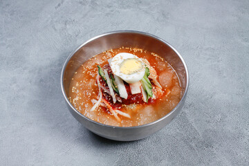 Cold Buckwheat Noodles (Korean cool noodles) decorated on thet marble table.