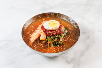 Cold Buckwheat Noodles (Korean cool noodles) decorated on thet marble table.