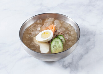 Cold Buckwheat Noodles (Korean cool noodles) decorated on thet marble table.
