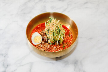 Cold Buckwheat Noodles (Korean cool noodles) decorated on thet marble table.