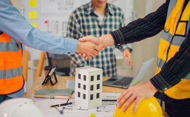 Engineers and architects discuss and consider construction plans for new renewable energy project...