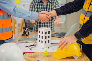 Engineers and architects discuss and consider construction plans for new renewable energy project...