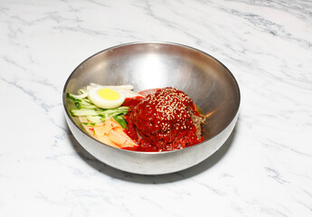 Cold Buckwheat Noodles (Korean cool noodles) decorated on thet marble table.