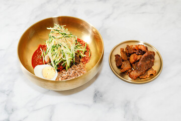 Cold Buckwheat Noodles (Korean cool noodles) decorated on thet marble table.