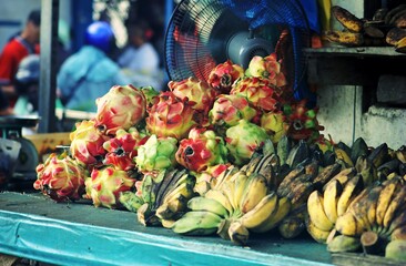 Exotic Fruits Display: Dragon Fruit and Bananas at Local Market