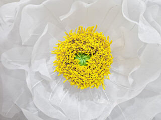 Background of the Chinese Peony flower craft in white, up close. Handcrafted Paeonia Lactiflora flower petals from organza fabric for decoration. Peony flowers symbolize purity, elegance and eternity.