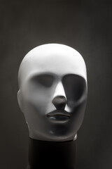 Mannequin head without eyes or hair. Humanoid shape.