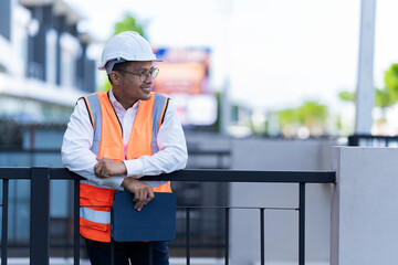 Construction workers check progress at a housing development site.
Engineer evaluates electrical...