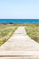 Wooden path to the beach. Rustic walkway leading to the seaside.