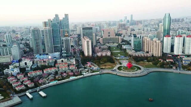 Discover stunning aerial views of Qingdao City coastline showcasing urban architecture and beautiful seascapes