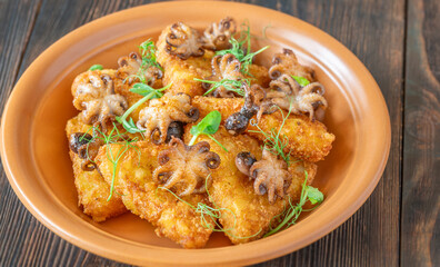 Golden Potato Rosti With Baby Octopuses And Fresh Pea Shoots Garnished Delicately