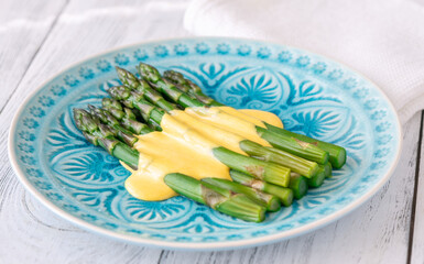Blue Plate of Boiled Asparagus Drizzled in Silky Hollandaise Sauce