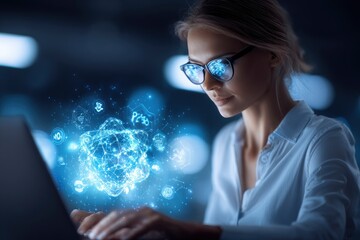 Woman in glasses works on a laptop with a glowing blue tech display