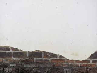 Exposed Brick Wall with White Plaster Damage
