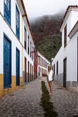 Tourist walking in picturesque narrow street in la gomera, canary islands, spain