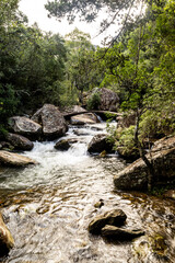 A small arched walking bridge crossing the Fast flowing Mahai river at Queens Causeway in Royal natal National Park in the Drakensberg Mountains of South Africa.