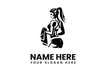 Silhouette of a fit woman with a ponytail, holding a towel, viewed from the back.