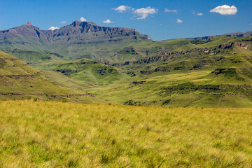 View over Giant’s Cup, one of the iconic mountains of the Drakensberg Mountain Range, in South Africa, with the Afro-montane grasslands in the foreground, on a clear and sunny day