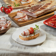 Meat delicacies and smoked meats sliced ​​on a light table