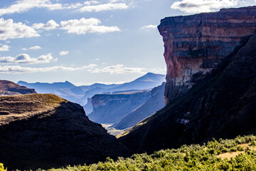 The iconic Brandwag sandstone buttress, with the distant blue mountains of the Drakensberg mountainrange in the background.