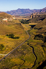 Looking down at a Highway cutting through the majestic sandstone cliffs of the Golden Gate Highlands National Park of South Africa.