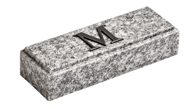 A granite desktop nameplate with engraved initials, white background --ar 16:9