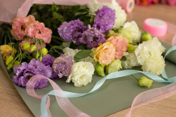 The process of assembling a bouquet of flowers in a flower shop. Neutral colors