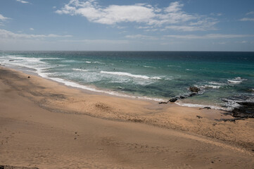 Vista panorámica de Piedra Playa con surfistas en el mar, en El Cotillo, Fuerteventura