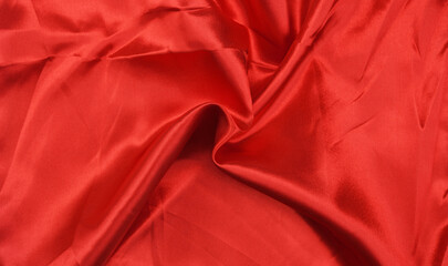 Rich red satin fabric draped elegantly across a surface.