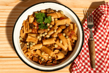 Delicious beef stew with rigatoni pasta, peas, and parsley garnish