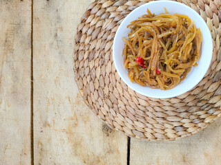 Selective focus. Stir-fried young papaya slices tastes spacy and delicious. Papaya fruit is cooked...