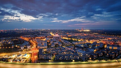Wide, aerial, night panorama of illuminated Vilanów district in Warsaw