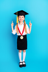 Delighted Elementary Schoolgirl Celebrating Achievement in Academic Attire Against Bright Blue...
