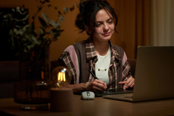 beautiful professional designer woman working at home workspace using digital graphic tablet and...