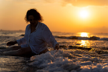 Meditating at sunrise on a serene beach