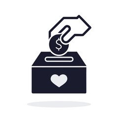 Hand dropping coin into donation box with heart charity giving