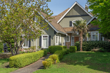 Two story stucco luxury house with nice spring blossom landscape in Vancouver, Canada, North...