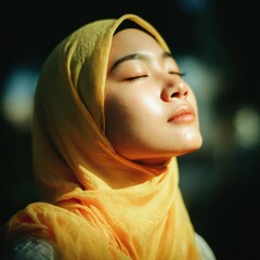 Woman in yellow hijab, peaceful, sunlit