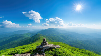 Fototapeta premium A mountain top with a small stone on it and a clear blue sky