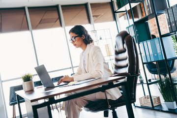 Professional businesswoman working at a desk in a modern office workspace