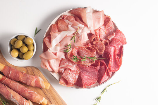 Charcuterie board. Antipasti appetizers of meat platter with salami, prosciutto crudo or jamon and olives.